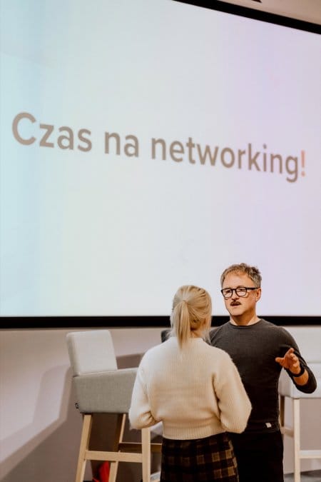 Conversations during the conference against the backdrop of the Time for Networking sign