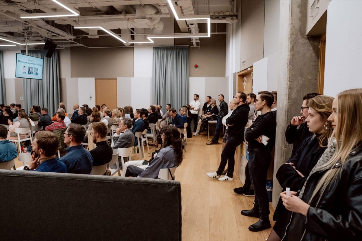 People standing by the wall during the conference