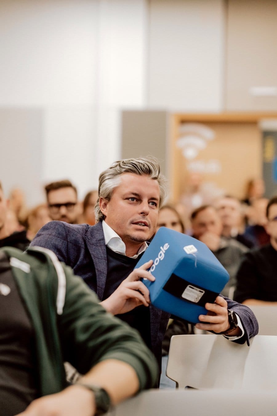 Elegant man speaks into Google's blue microphone