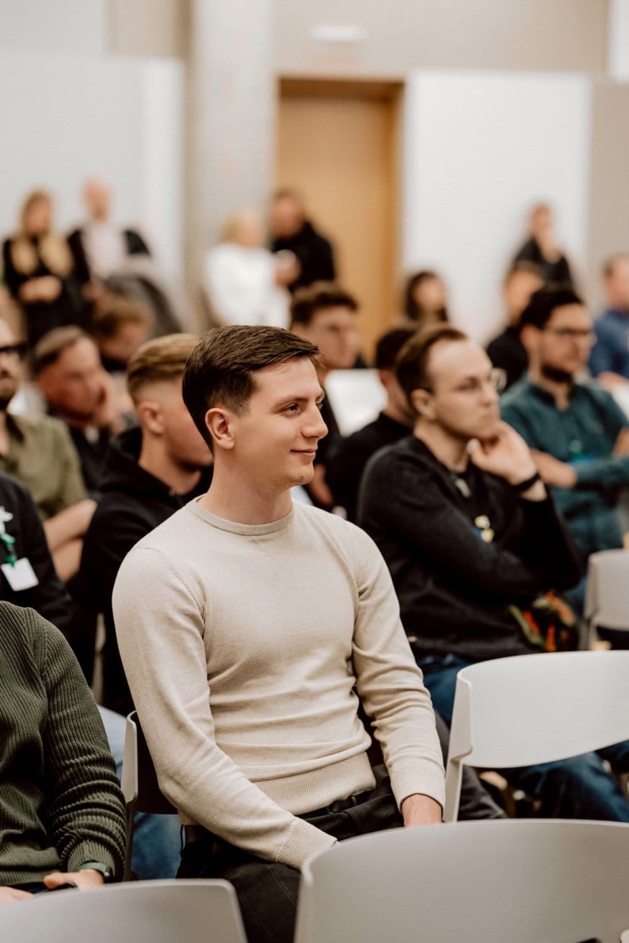 Boy in cream sweater at Aula Poland conference