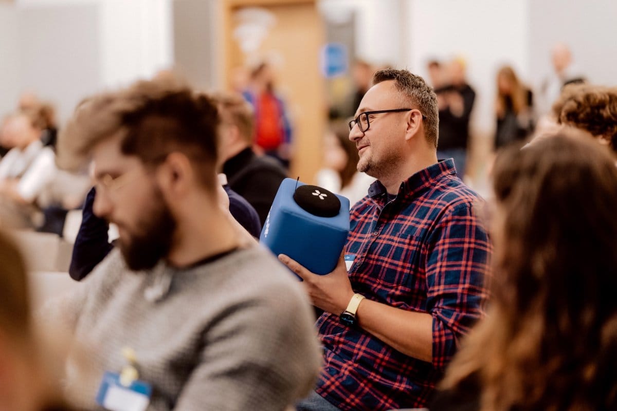 Conference participant holding a blue plush microphone