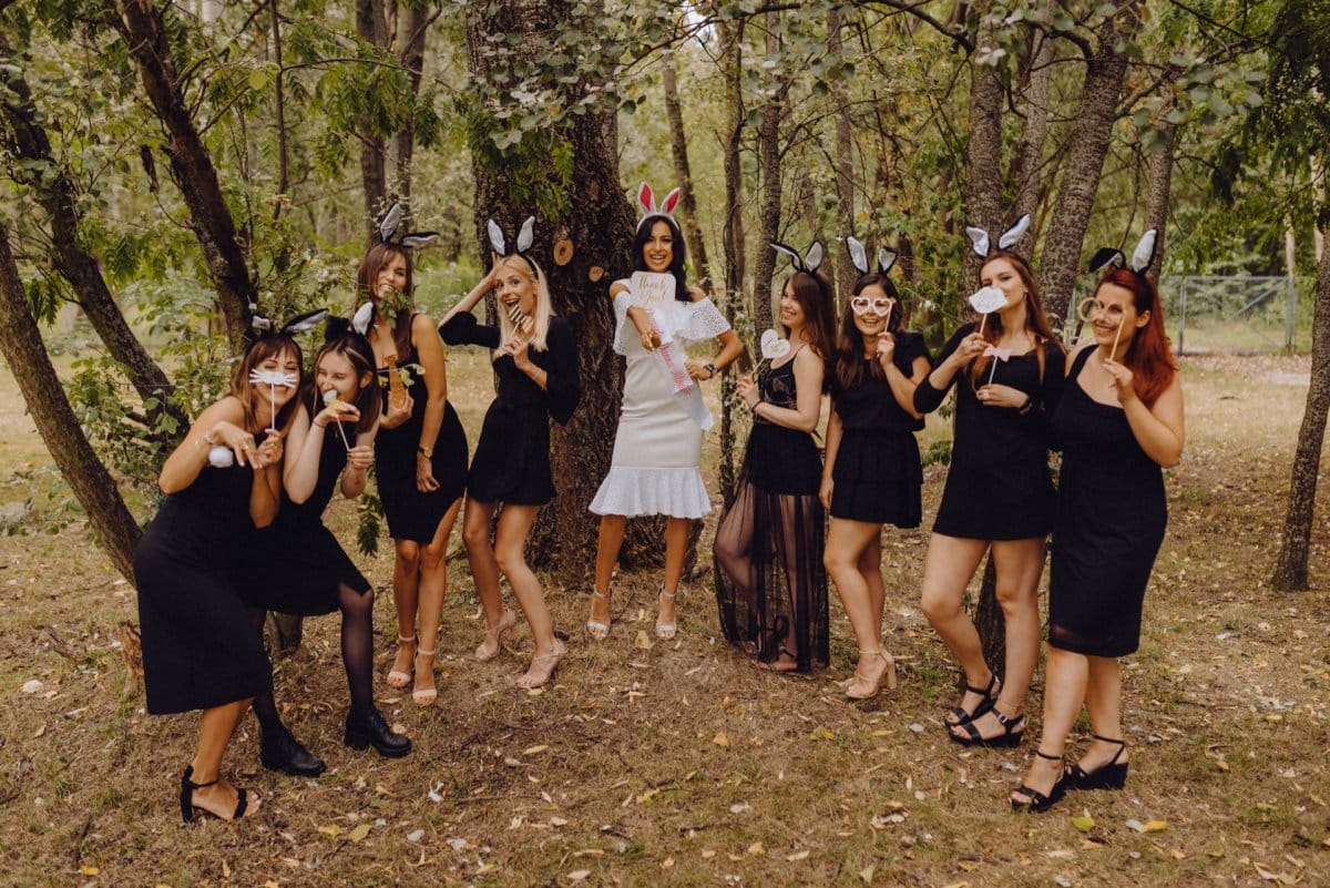 Girls in bunny ears pose with gadgets for photos