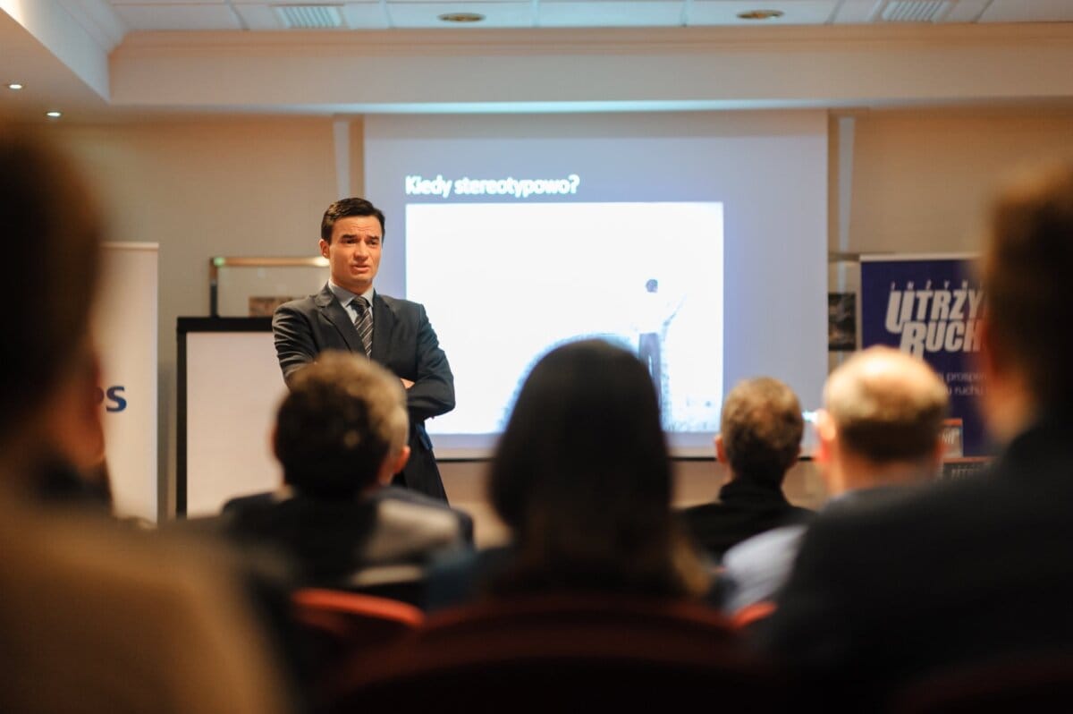 Elegant man speaks to audience in training room