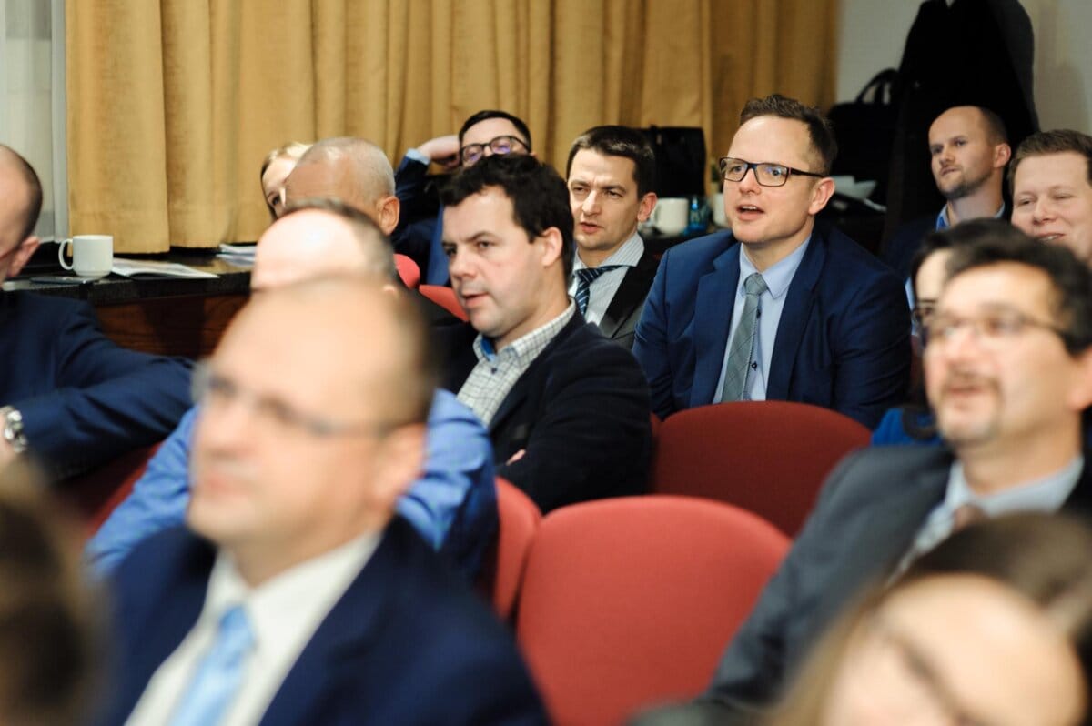 A group of people sitting on chairs in a conference room