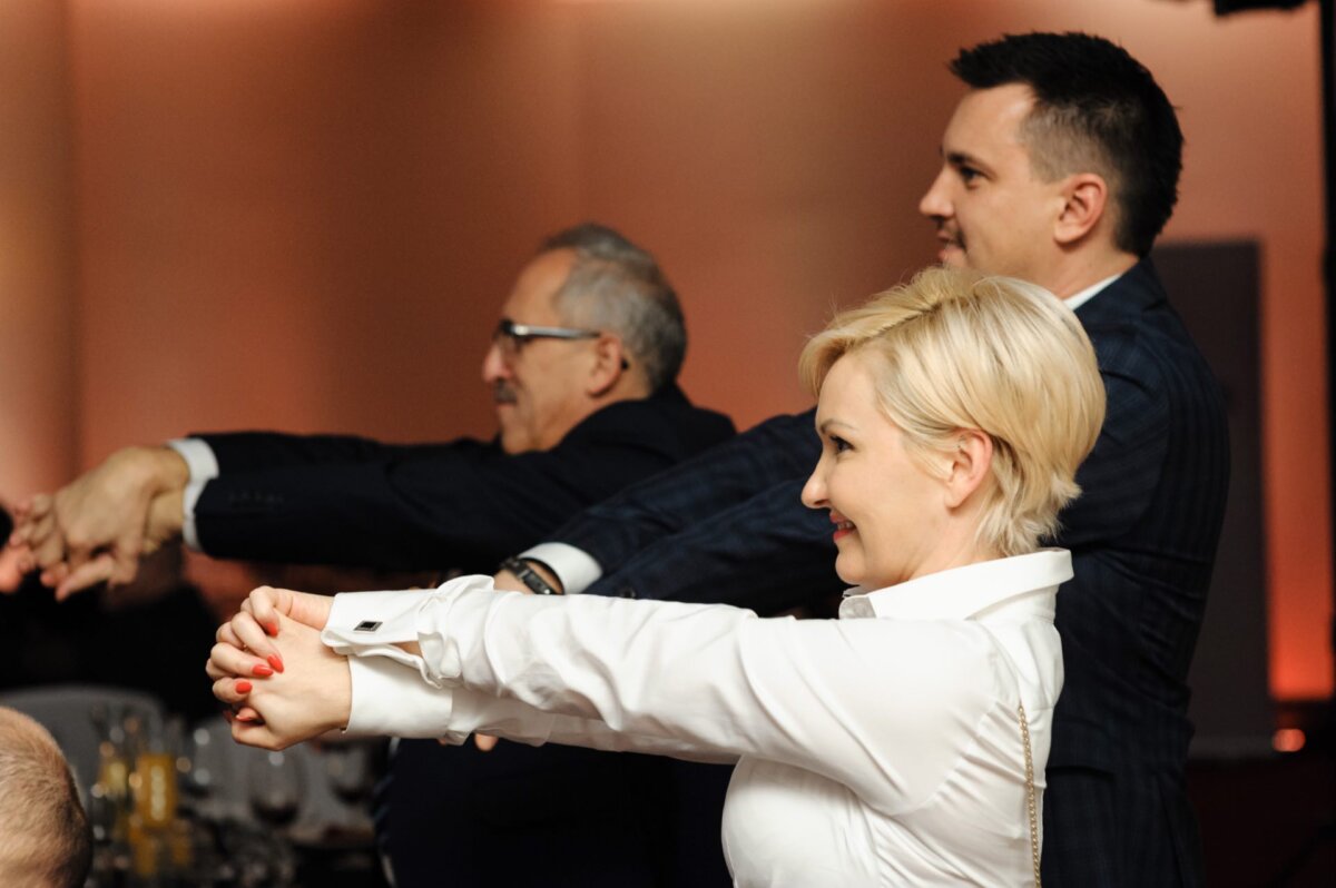 A woman and two men hold their hands in front of them