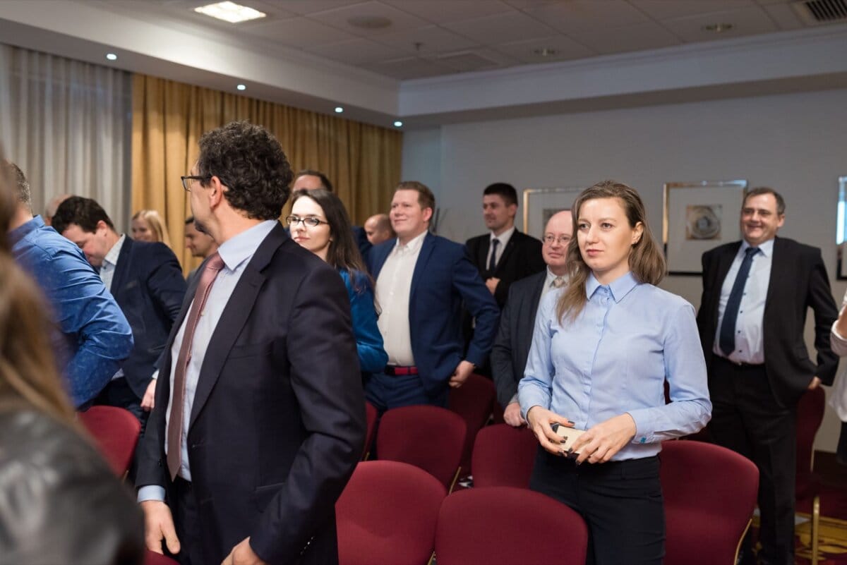 Trainees standing between chairs