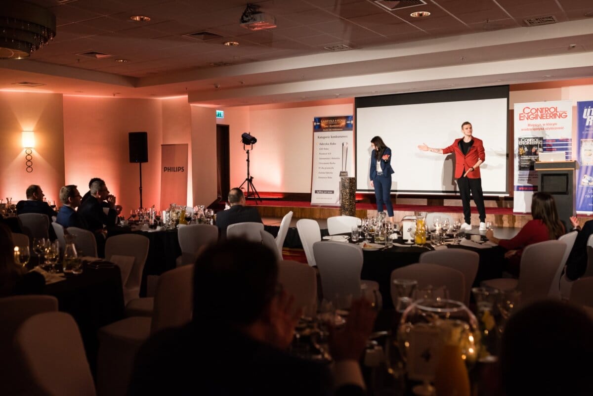 Man and woman on stage at a banquet