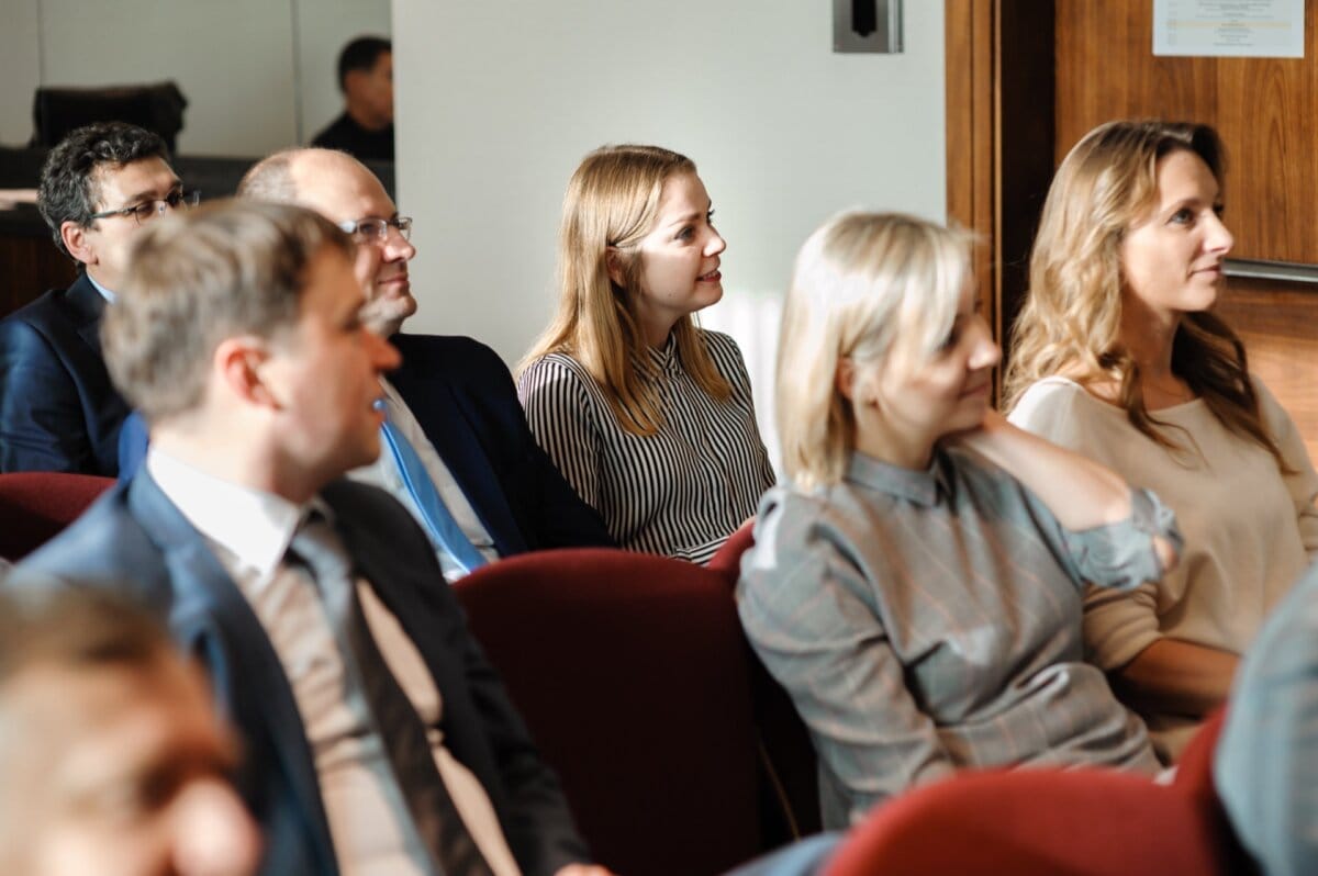 Woman in striped shirt sitting in the audience