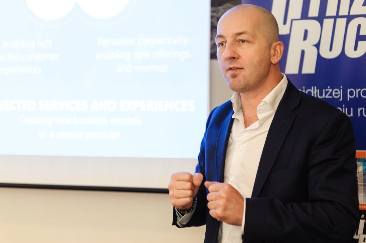 Bald man clenches fists against the backdrop of presentation