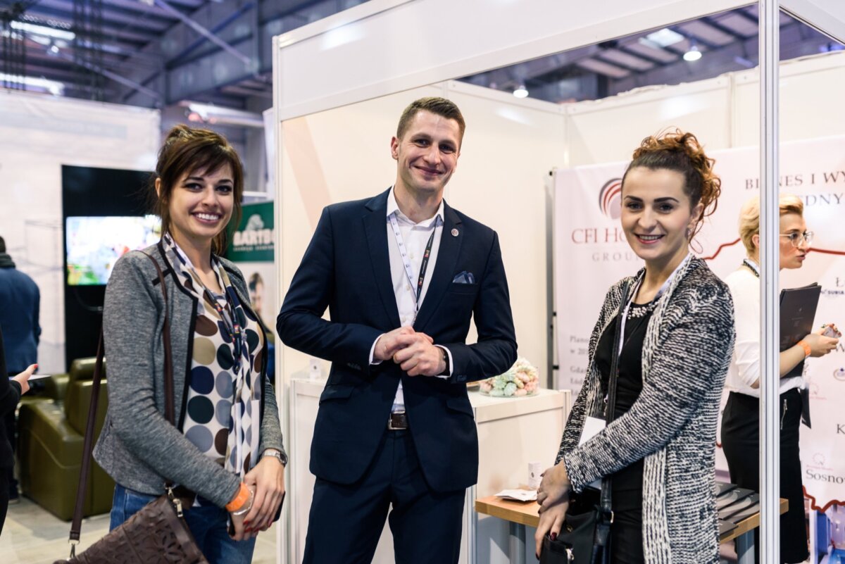 A man and two women at a market stall