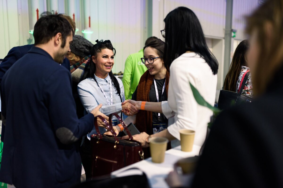 Women greeting each other while networking