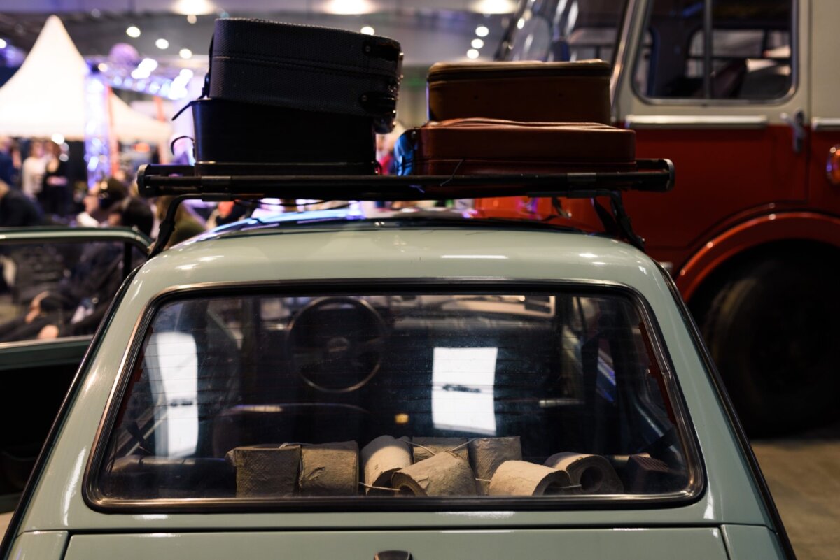 Window of the car toddler in which lie rolls of gray toilet paper on a string