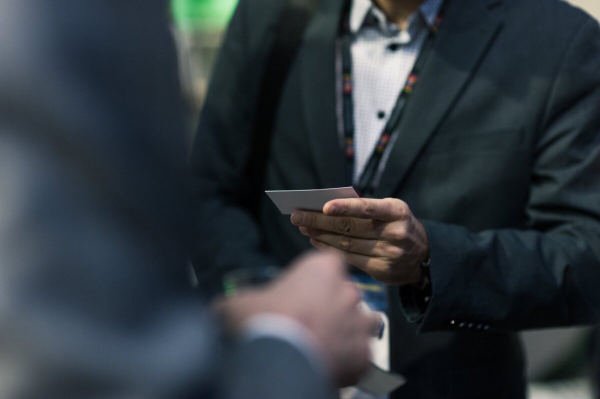 presenting a business card at an event industry forum