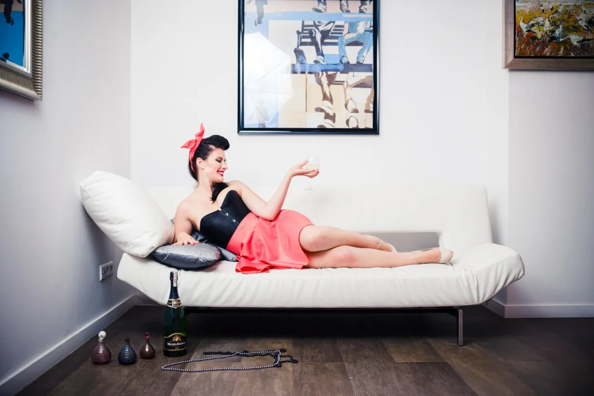 Pinup style woman lies on couch