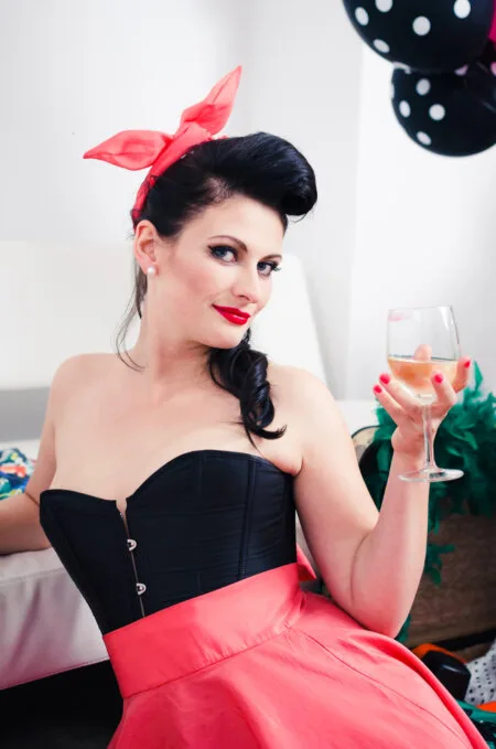 Girl with a glass dressed in pinup style