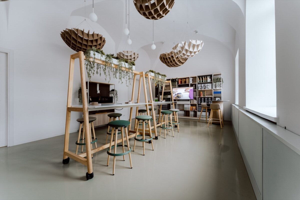 Bar-height workstations with stools in the Narbutas showroom in Warsaw