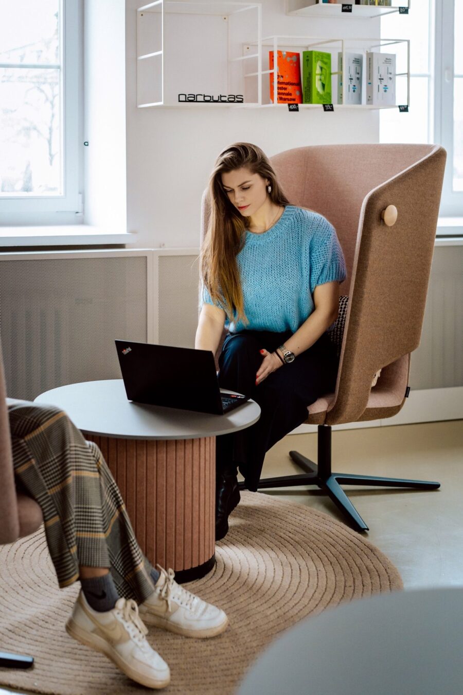 Working on a laptop in a Narbutas armchair with an acoustic shield
