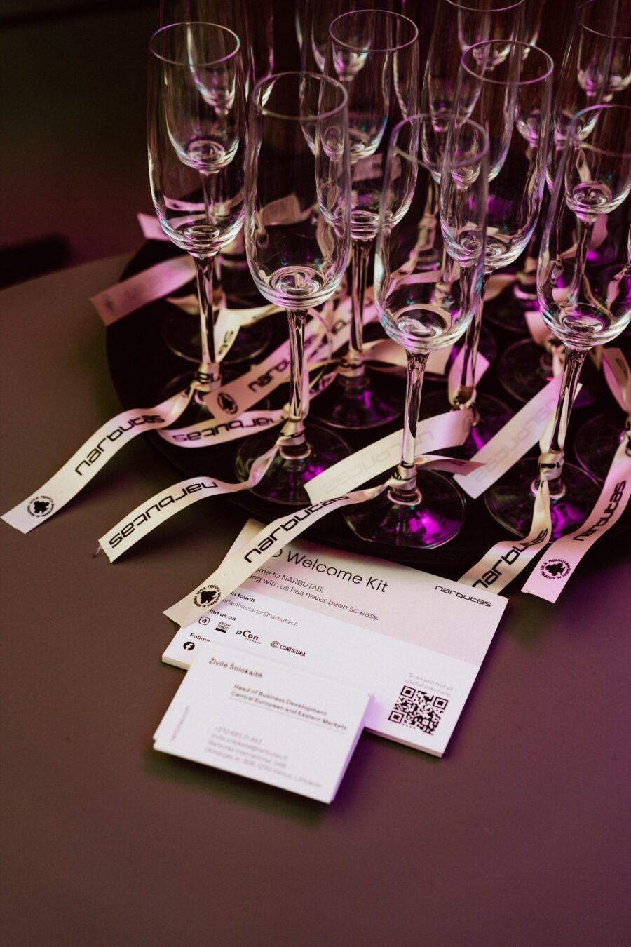 Glasses and business cards welcoming guests to the Narbutas showroom opening