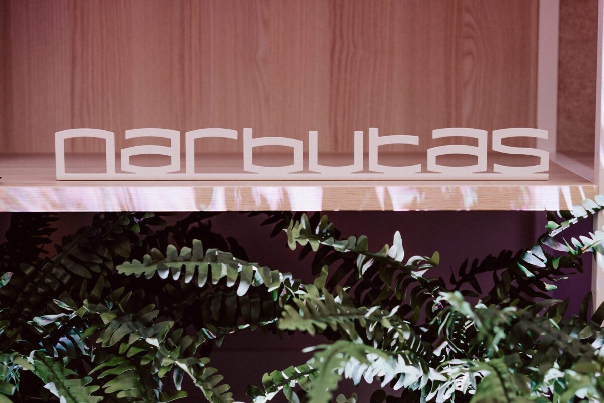 Narbutas logo above greenery in the showroom prepared for the opening