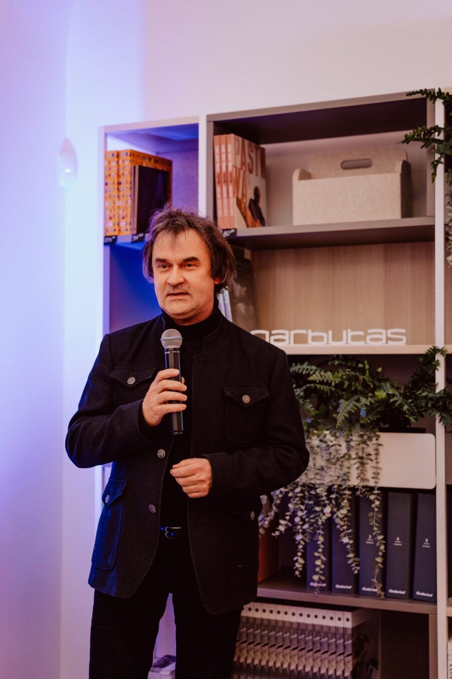 A speech with a microphone at the Narbutas showroom opening
