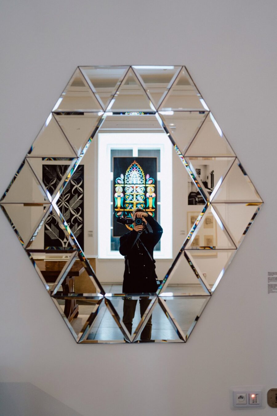 Mirror in the Academy of Fine Arts building reflecting a stained glass window