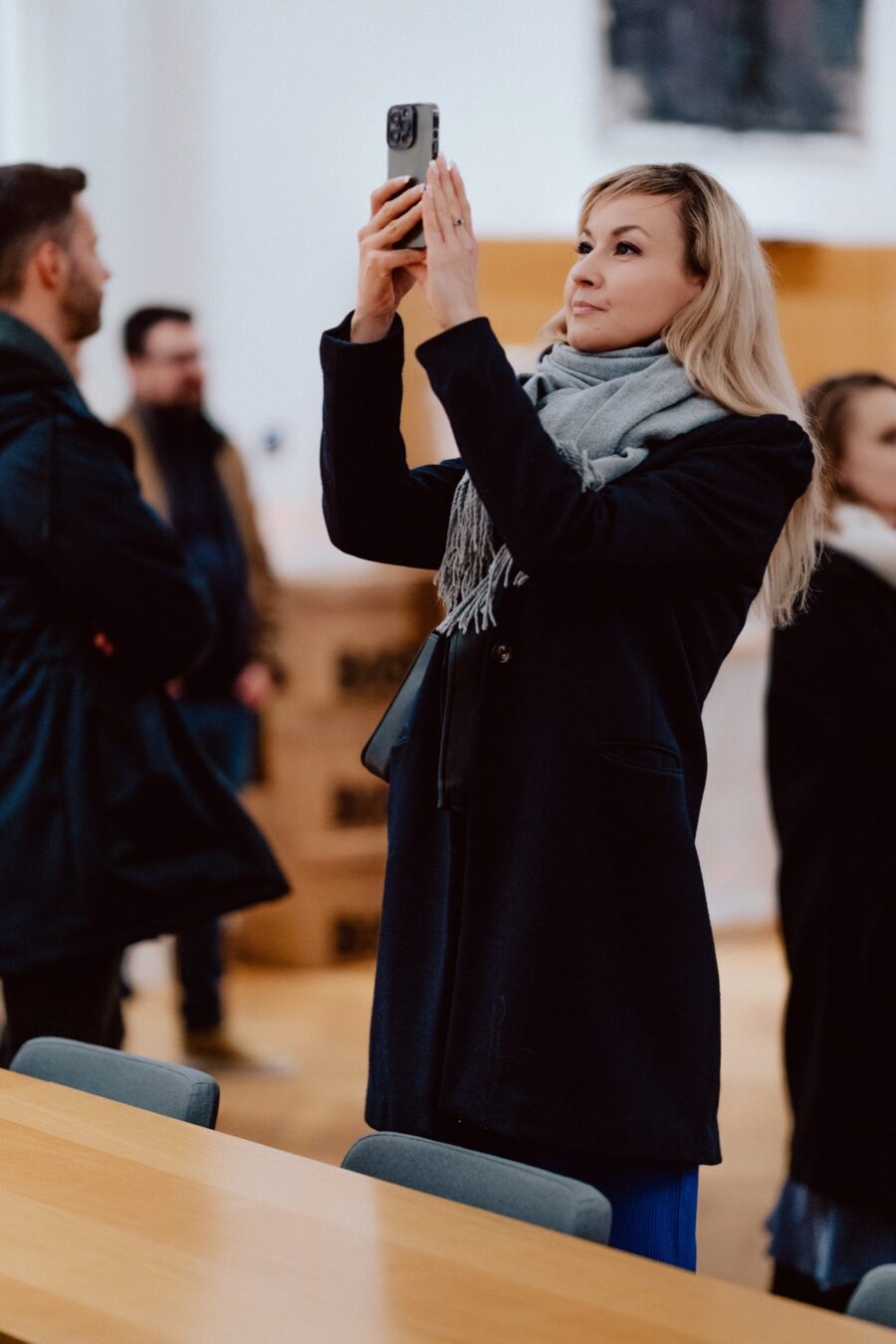 A guest photographing the exhibition in the Academy of Fine Arts building