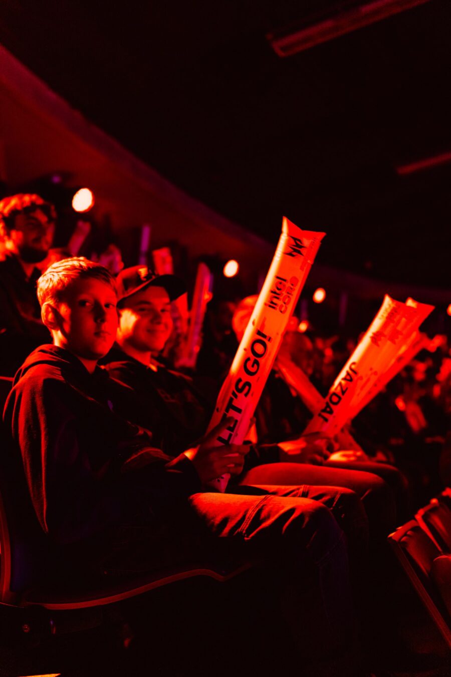 Kibice z dmuchanymi pałkami w czerwonym świetle areny, IEM Katowice 2024